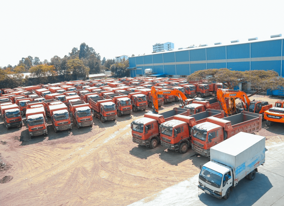 Fleet of dump trucks and excavators in the yard